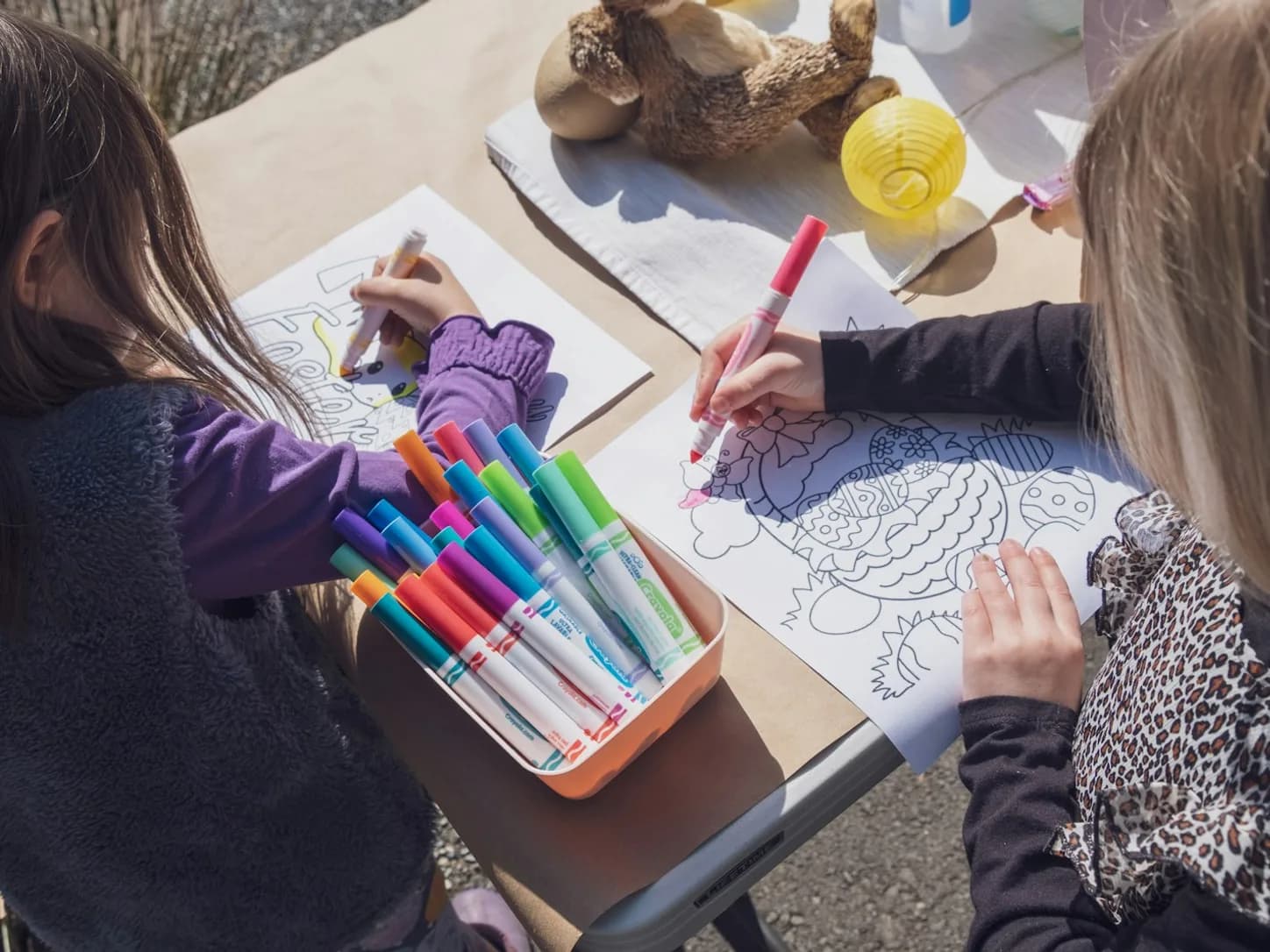 Children coloring together during a summer camp activity